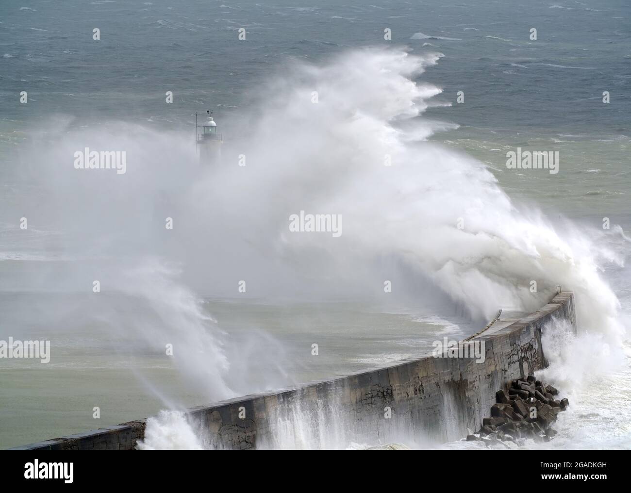 Newhaven, East Sussex, UK. 30th July, 2021. Waves crash over Newhaven's Breakwater as Storm Evert brings rough seas to the south coast. East Sussex. Credit: Peter Cripps/Alamy Live News Stock Photo