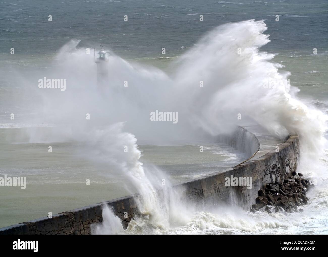 Newhaven, East Sussex, UK. 30th July, 2021. Waves crash over Newhaven's Breakwater as Storm Evert brings rough seas to the south coast. East Sussex. Credit: Peter Cripps/Alamy Live News Stock Photo