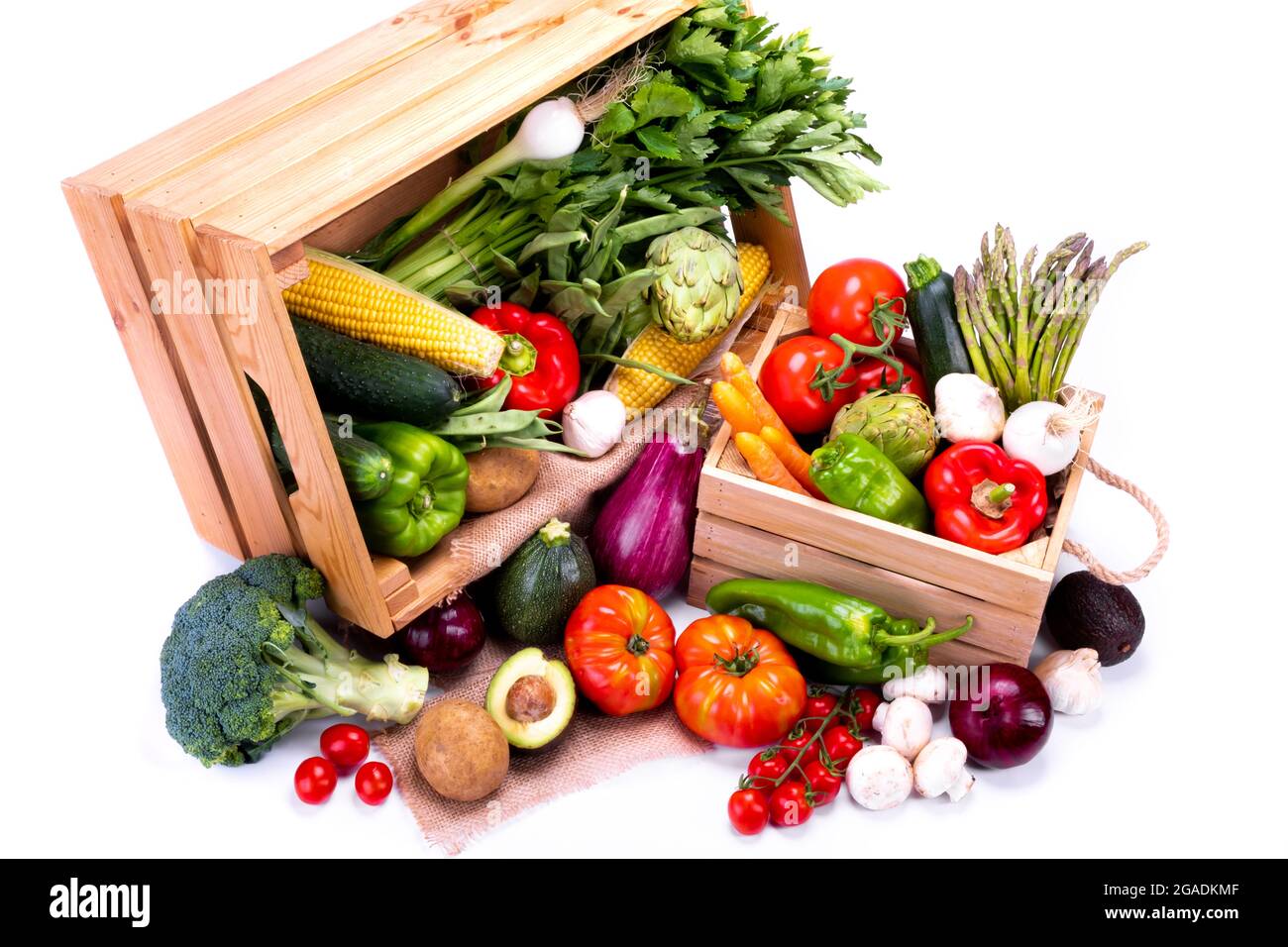 Top view of wooden boxes full of fresh vegetables on a white background ...