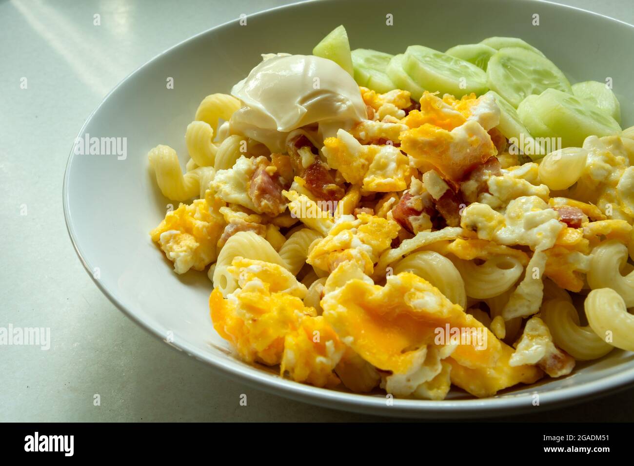 Scrambled eggs with bacon and mayonnaise in a white plate Stock Photo