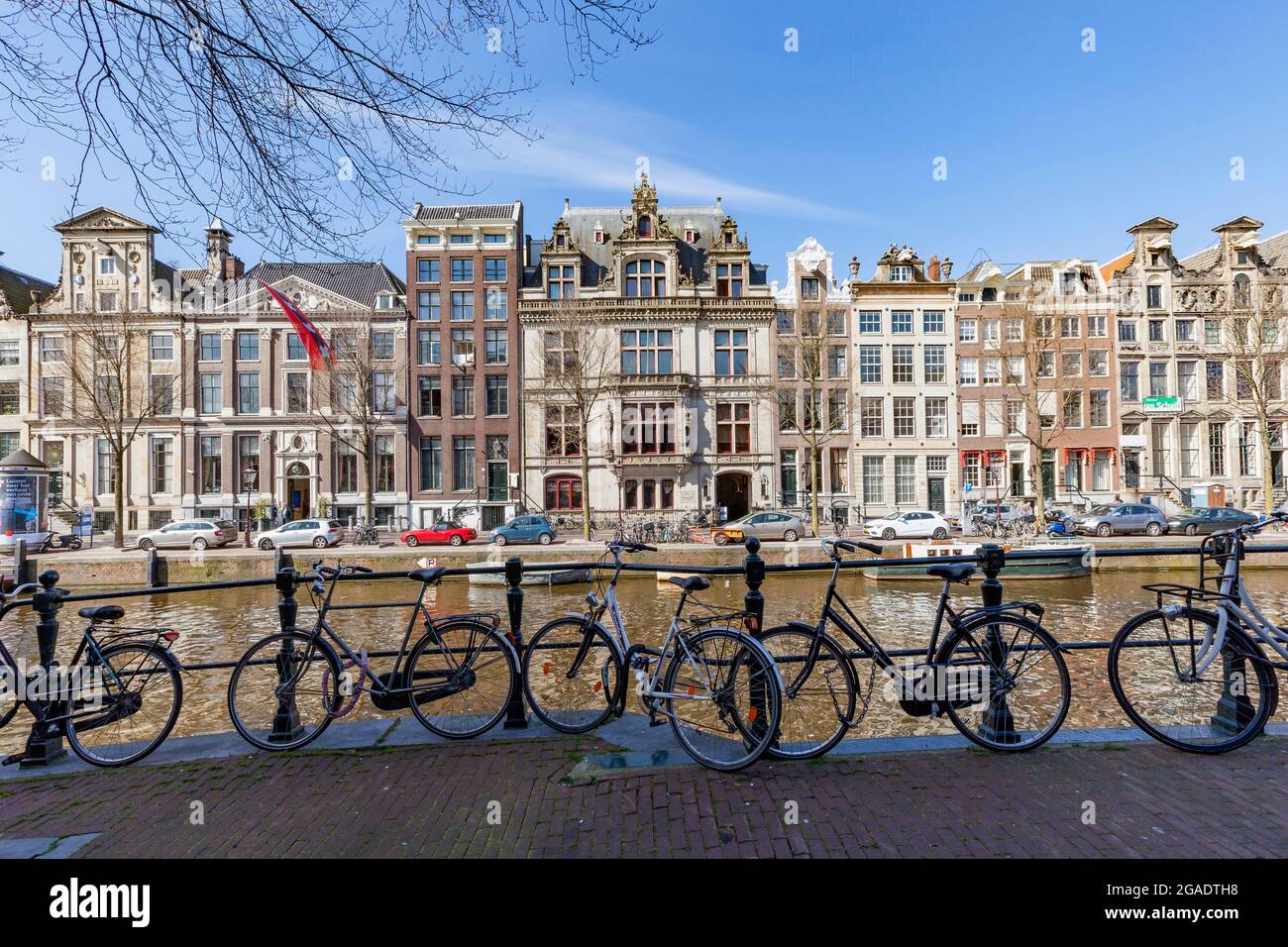 Bicycles parked on Herengracht, opposite gabled buildings, including Grachtenmuseum, Amsterdam, the Netherlands Stock Photo