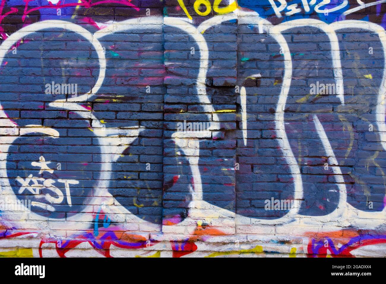 Wall with colored graffiti with letters. Stock Photo
