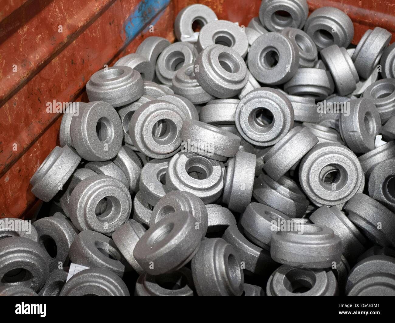Heap of gear blanks with bore at the workshop. Manufacturing of cylindrical gears Stock Photo