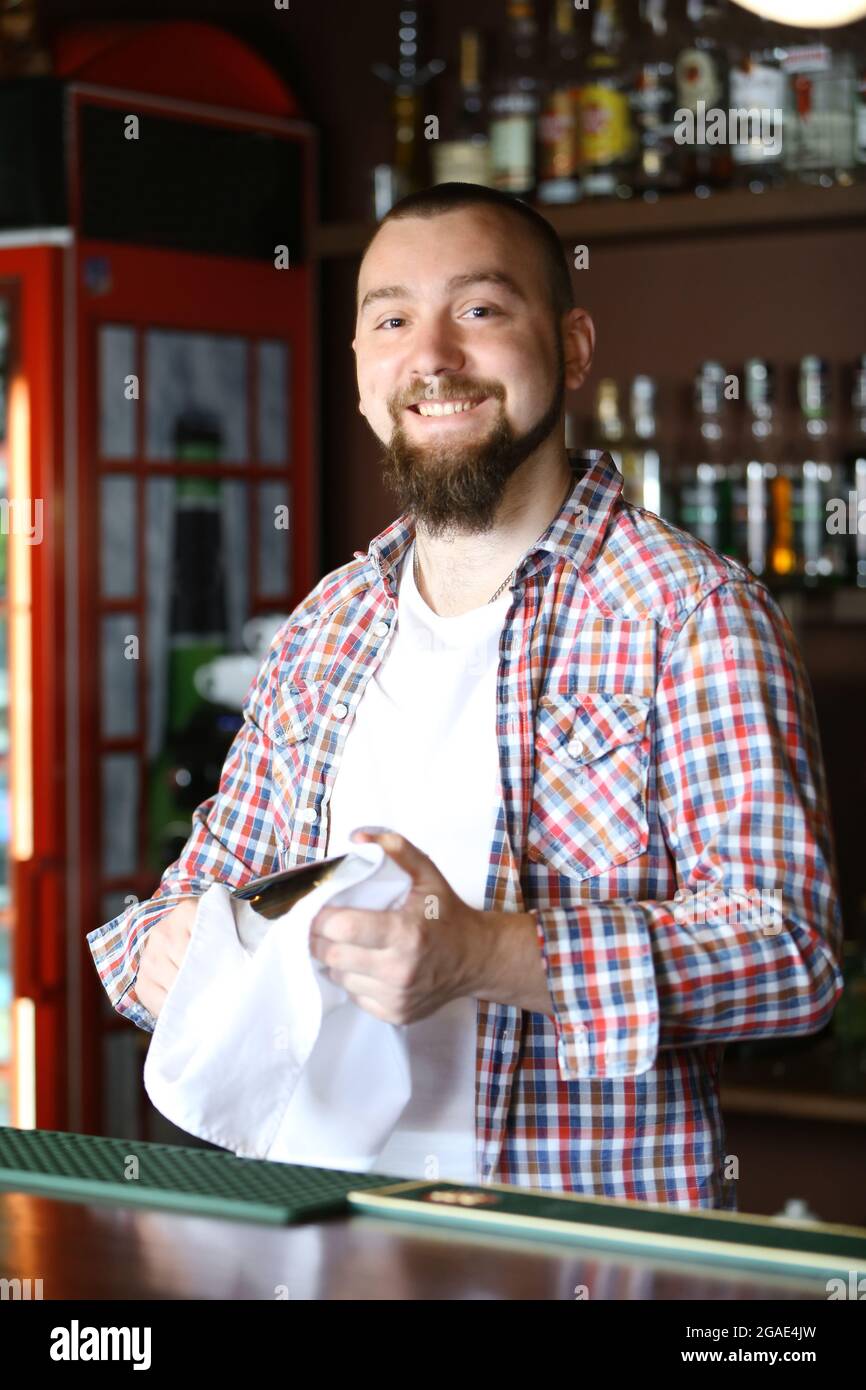 Bartender wipes glasses at work Stock Photo Alamy