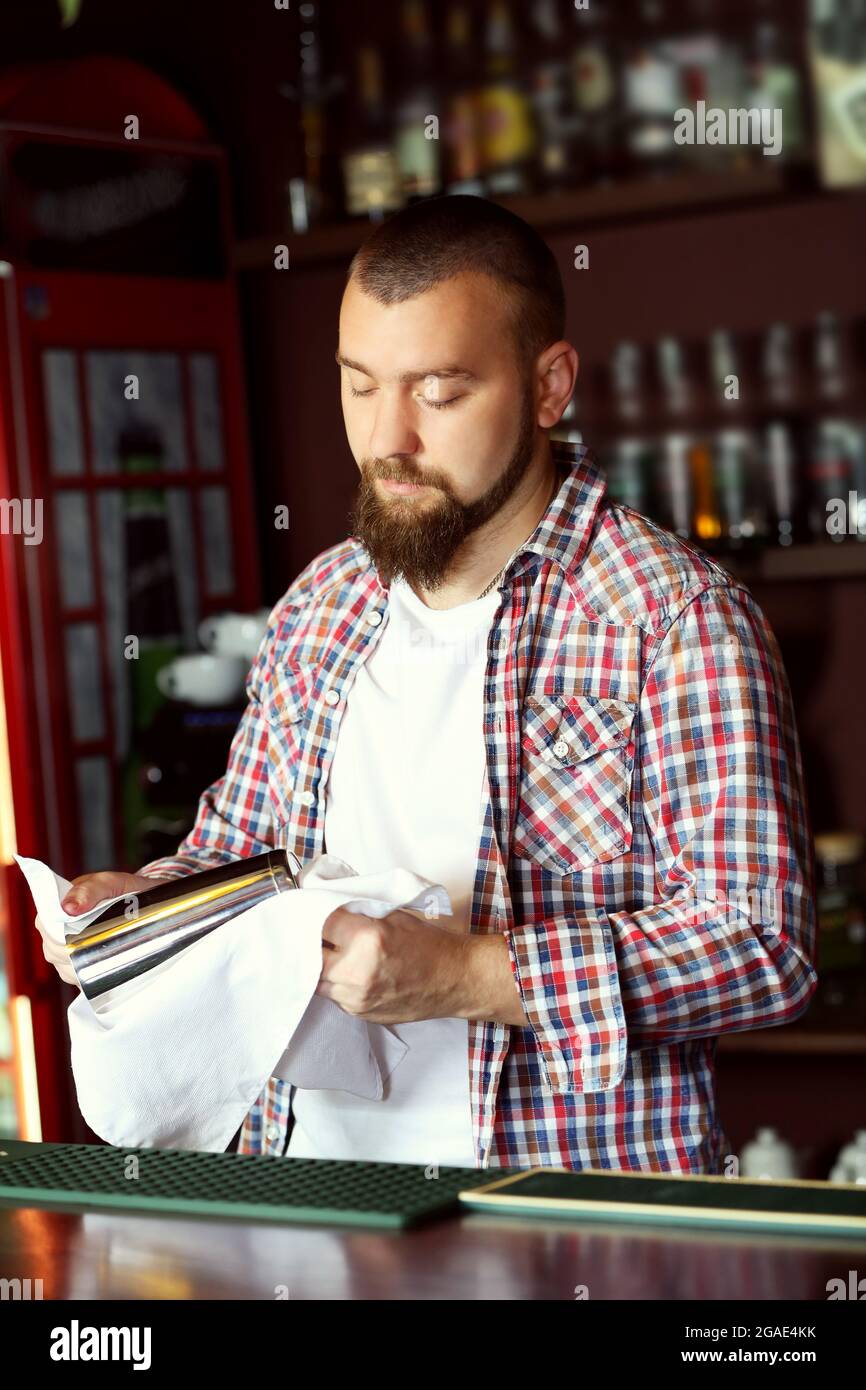 Bartender wipes glasses at work Stock Photo Alamy