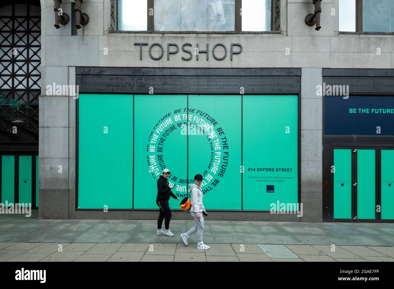 London, UK. 30 July 2021. People pass the empty Topshop flagship store on Oxford  Street. According to a report from the British Retail Consortium (BRC) and  Local Data Company, one in seven
