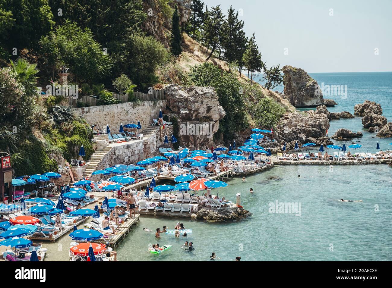 Antalya, Turkey - 30 July 2021: Mermerli beach in Antalya Turkey. Wonderful summer sunny turquoise beach on the Mediterranean coast. Rest, tourism and travel concept. . High quality photo Stock Photo