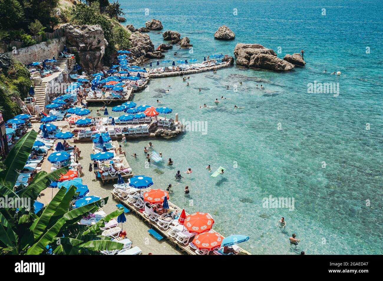 Antalya, Turkey - 30 July 2021: Mermerli beach in Antalya Turkey. Wonderful summer sunny turquoise beach on the Mediterranean coast. Rest, tourism and travel concept. . High quality photo Stock Photo