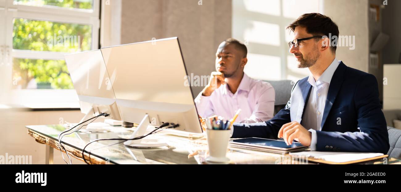 African American Business Man Employee Working In Office With Colleague Stock Photo