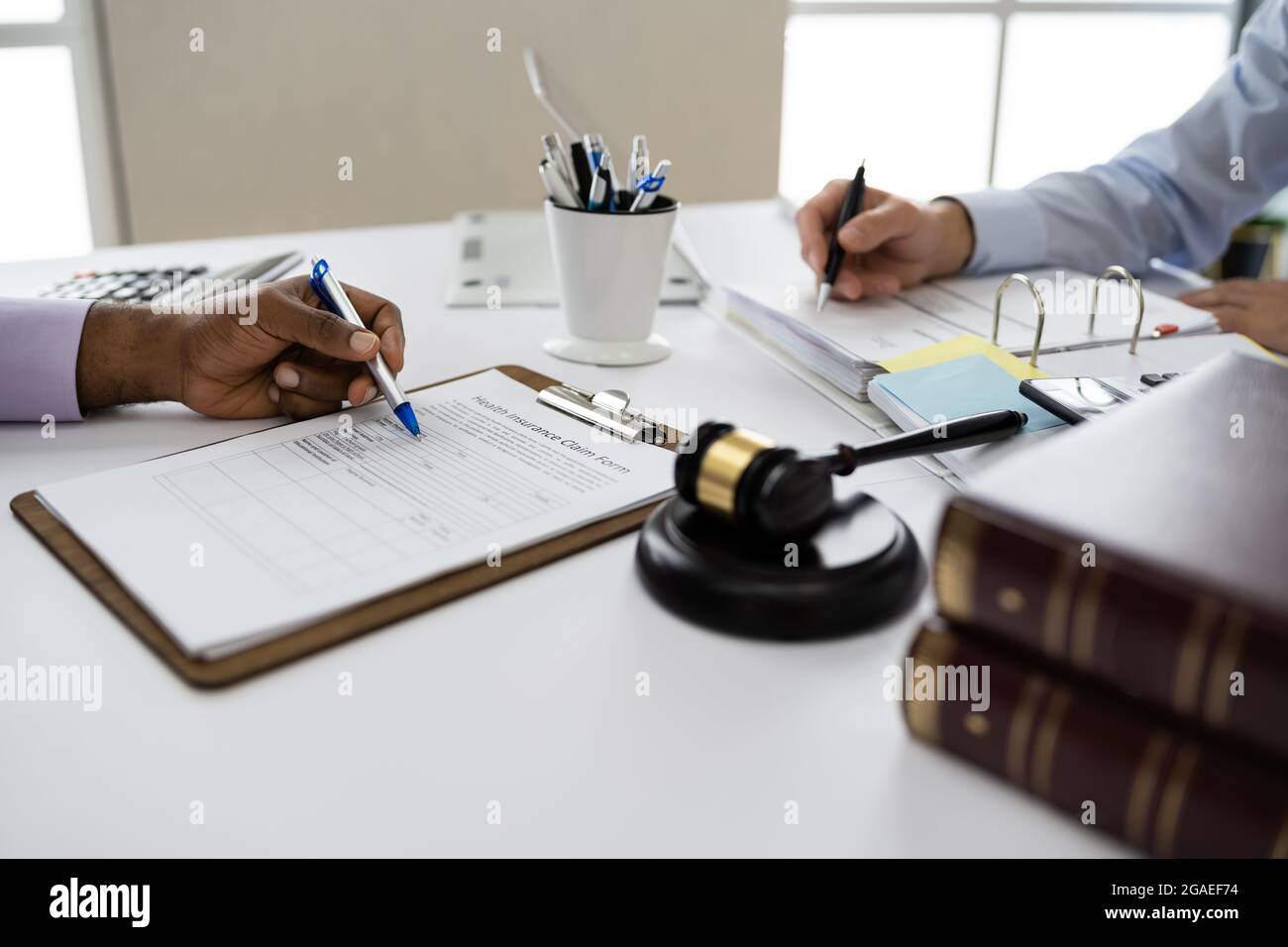 Client And Lawyer In Courtroom. Judicial Verdict Stock Photo