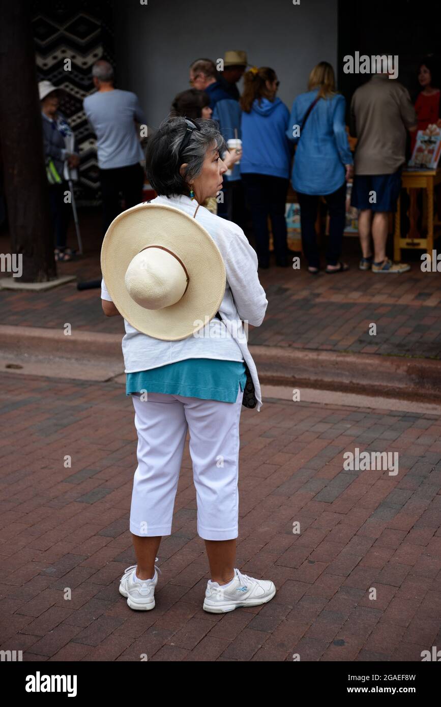 An hispanic artist observes the crowd at an outdoor art festival in Santa Fe, New Mexico. Stock Photo