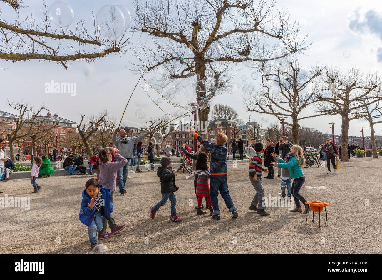 Children playing with soap bubbles in Museum Square, Amsterdam Stock ...