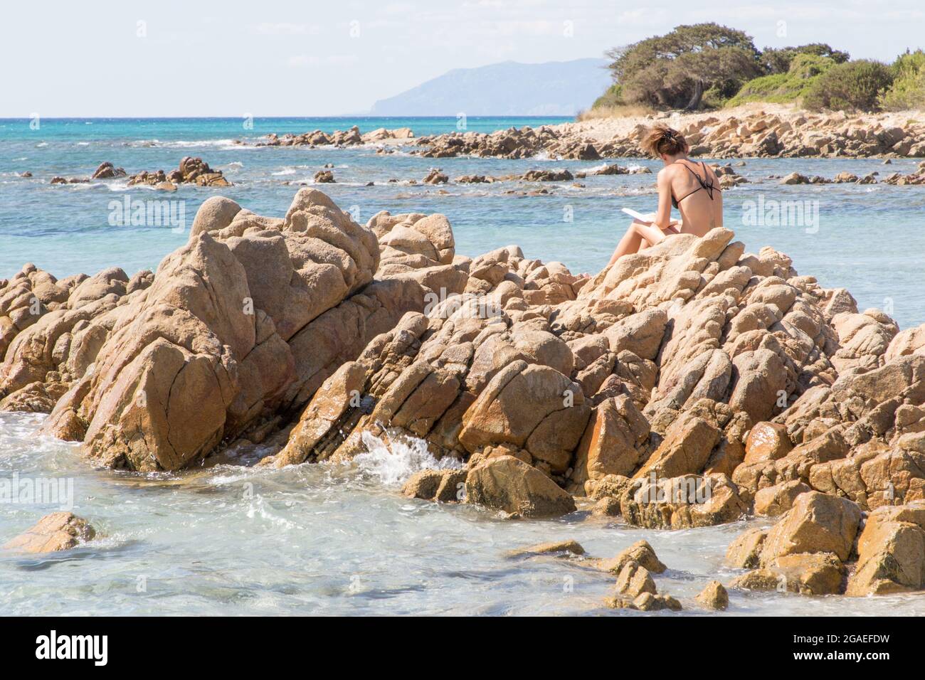 July 23 21 Girl Reads A Book Sitting On The Rocks In Front Of The Crystalline Sea Near The Beach Of La Cinta Sardinia Stock Photo Alamy July 23 21 Girl Reads A Book Sitting On The Rocks In Front Of The Crystalline Sea Near The Beach Of La Cinta Sardinia Stock Photo Alamy