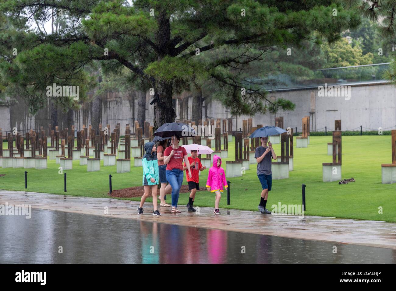 Oklahoma City, Oklahoma - Visitors at the Oklahoma City National Memorial during a rain storm. The Memorial marks the 1995 domestic terror bombing tha Stock Photo