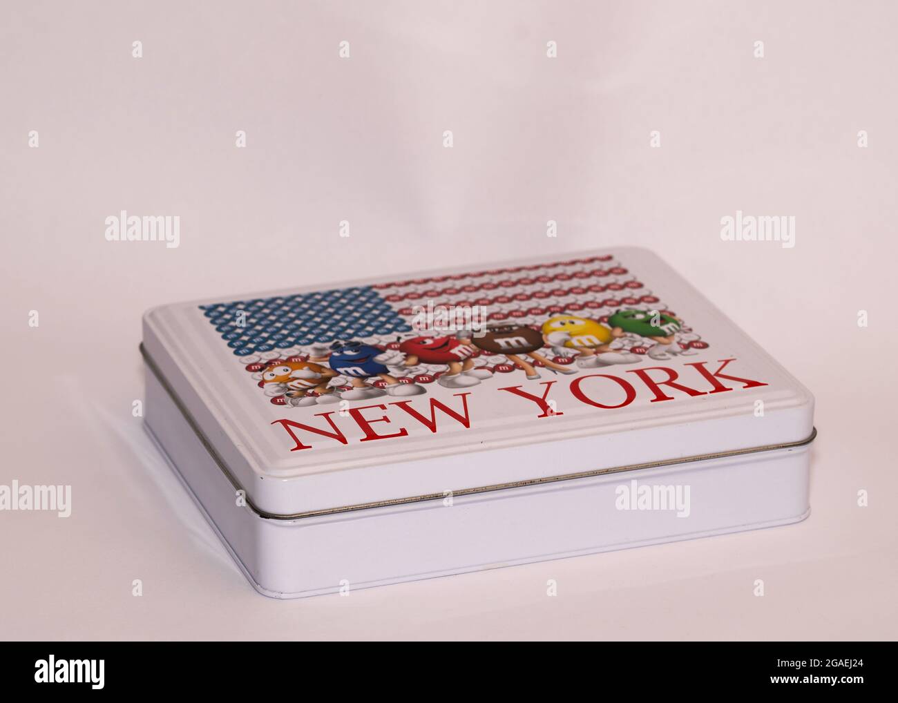 M and M oblong metal sweet tin with the name New York in red lettering across the top with an american flag Stock Photo