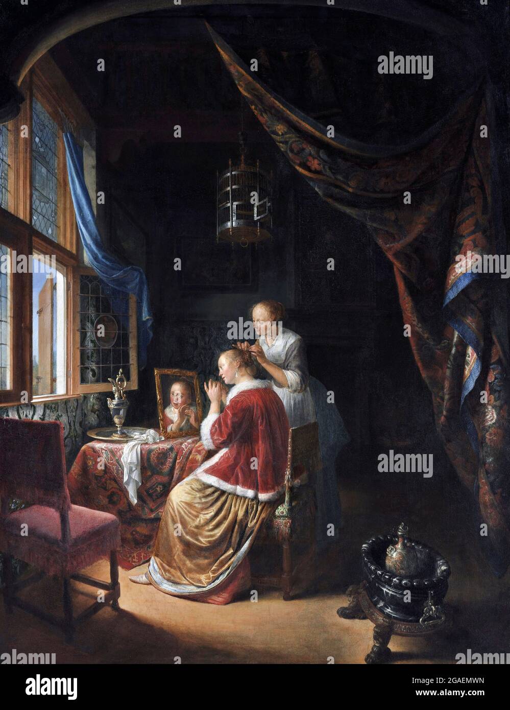 A Young Woman at her Toilet by Gerrit Dou (1613-1675), oil on panel, 1667 Stock Photo