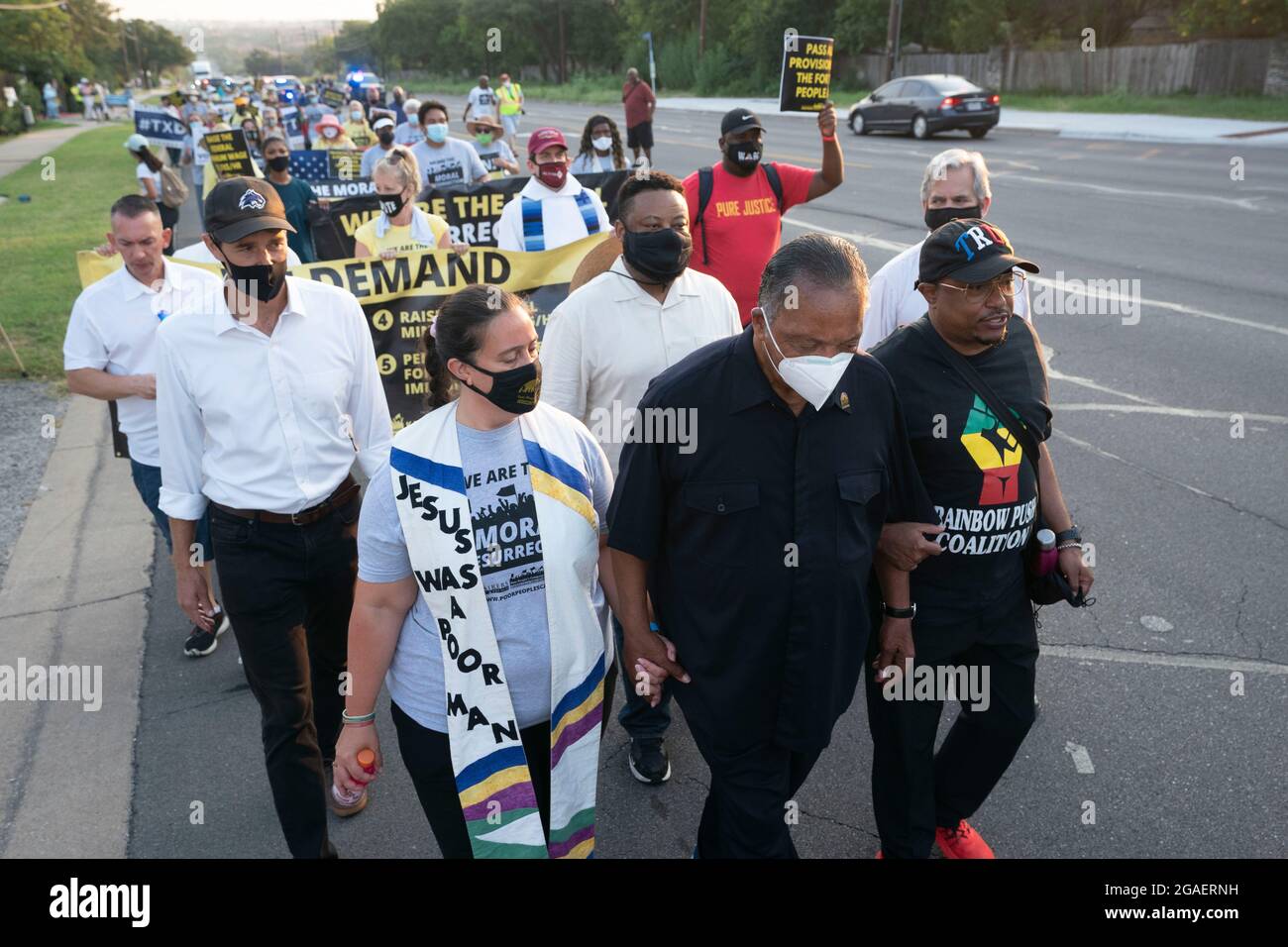 Austin, Texas USA, July 30, 2021: Faith leaders headed by legendary Democratic activist JESSE JACKSON (in black) as voting rights groups march toward the Texas Capitol from north Austin on the third day of a 30-mile journey protesting Republican efforts to suppress votes nationwide and in Texas. Former Texas congressman and voting rights activist Beto O'Rourke is on the left side of the second row. Credit: Bob Daemmrich/Alamy Live News Stock Photo
