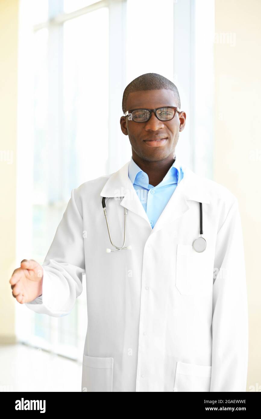 Handsome African American doctor with stethoscope in hospital Stock