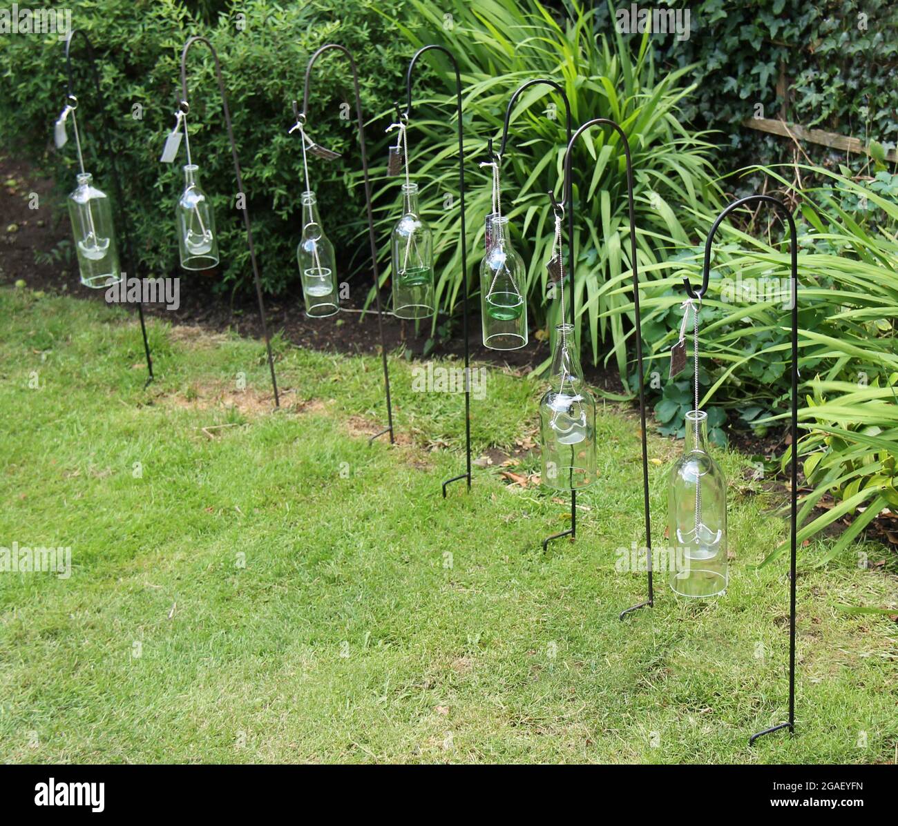 A Collection of Hanging Glass Bottle Candle Holders Stock Photo Alamy