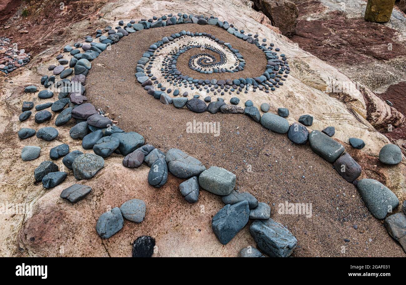 Stone or rock sculpture spiral pattern on the beach, Dunbar, East Lothian, Scotland, UK Stock Photo