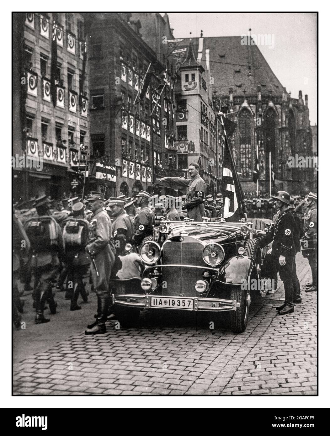 ADOLF HITLER SA TROOPS PARADE 1930s HEIL HITLER SALUTE  Reichsparteitag. Der Vorbeimarsch der SA am Führer. Parade of SA troops past Adolf Hitler in open top Mercedes motor car with Field Marshall Hermann Goering visible standing to his left Nuremberg, Germany November 1935. Adolf Hitler in the 1930's taking a parade salute with the Nazi brown shirt army (Sturmabteilung) and his Waffen SS protection squad Stock Photo
