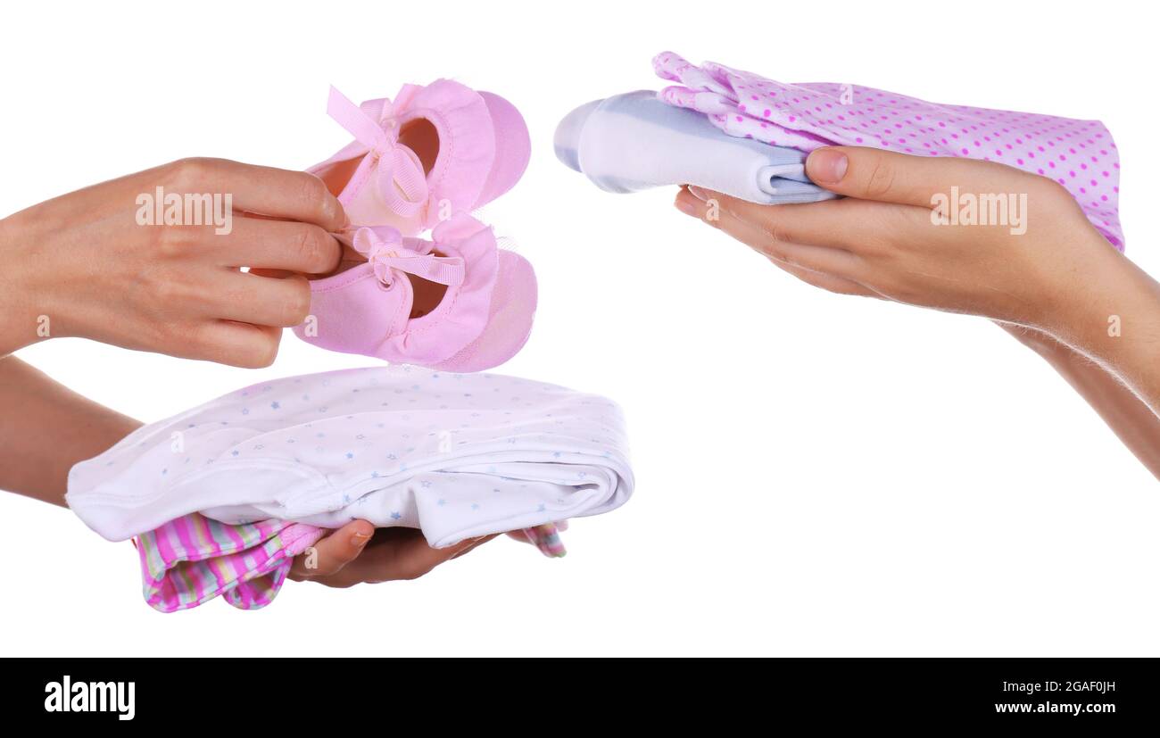 Concept of childish goods sale woman's hands keep clothes pile