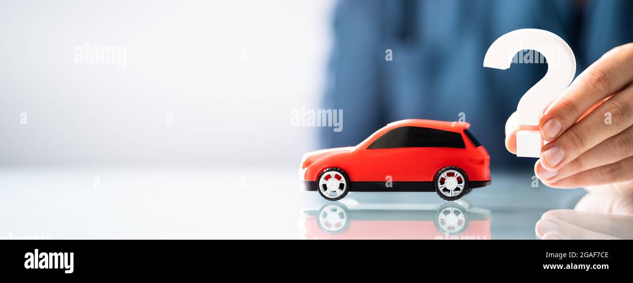 Person Hand Holding Question Mark Next To Car Model Stock Photo Alamy