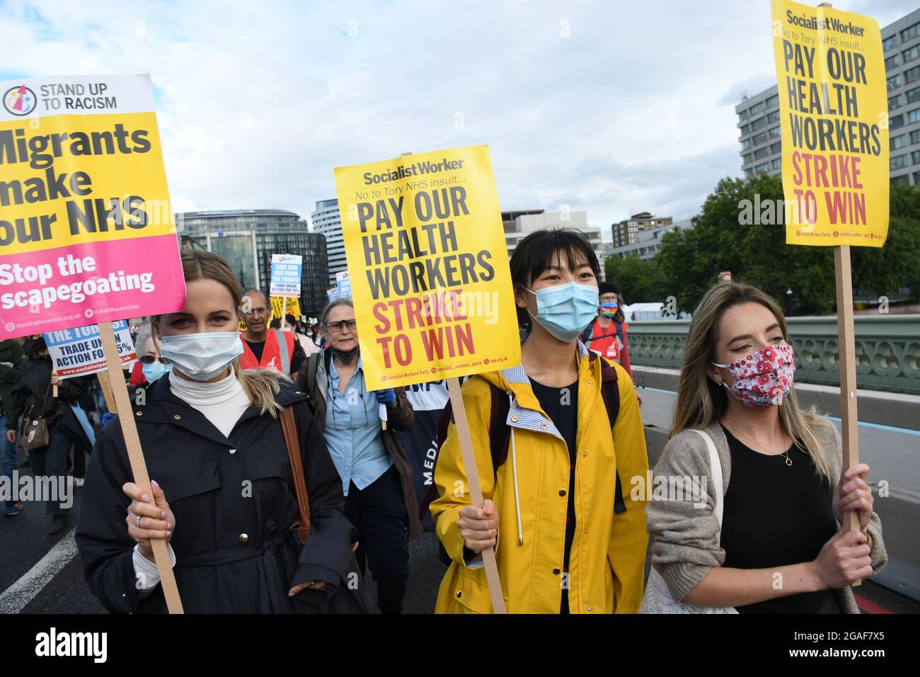 London, UK. 30th July, 2021. Doctors and nurses assembly at St Thomas' hospital for a march to Downing St demanding a proper pay rise for NHS workers, protest against the insulting 3% pay increase to NHS staff on 30 July 2021, London, UK. Credit: Picture Capital/Alamy Live News Stock Photo
