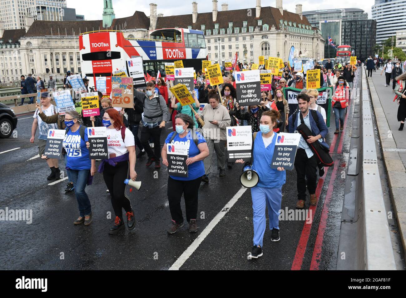 London, UK. 30th July, 2021. Doctors and nurses assembly at St Thomas' hospital for a march to Downing St demanding a proper pay rise for NHS workers, protest against the insulting 3% pay increase to NHS staff on 30 July 2021, London, UK. Credit: Picture Capital/Alamy Live News Stock Photo