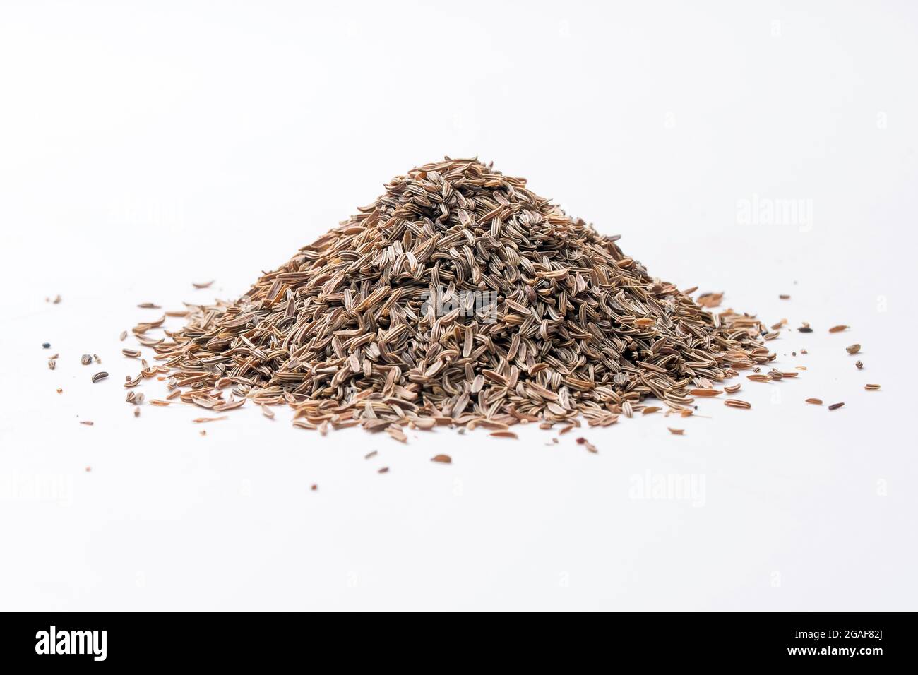 Bitter cumin, Cuminum cyminum heap, shot against white background Stock