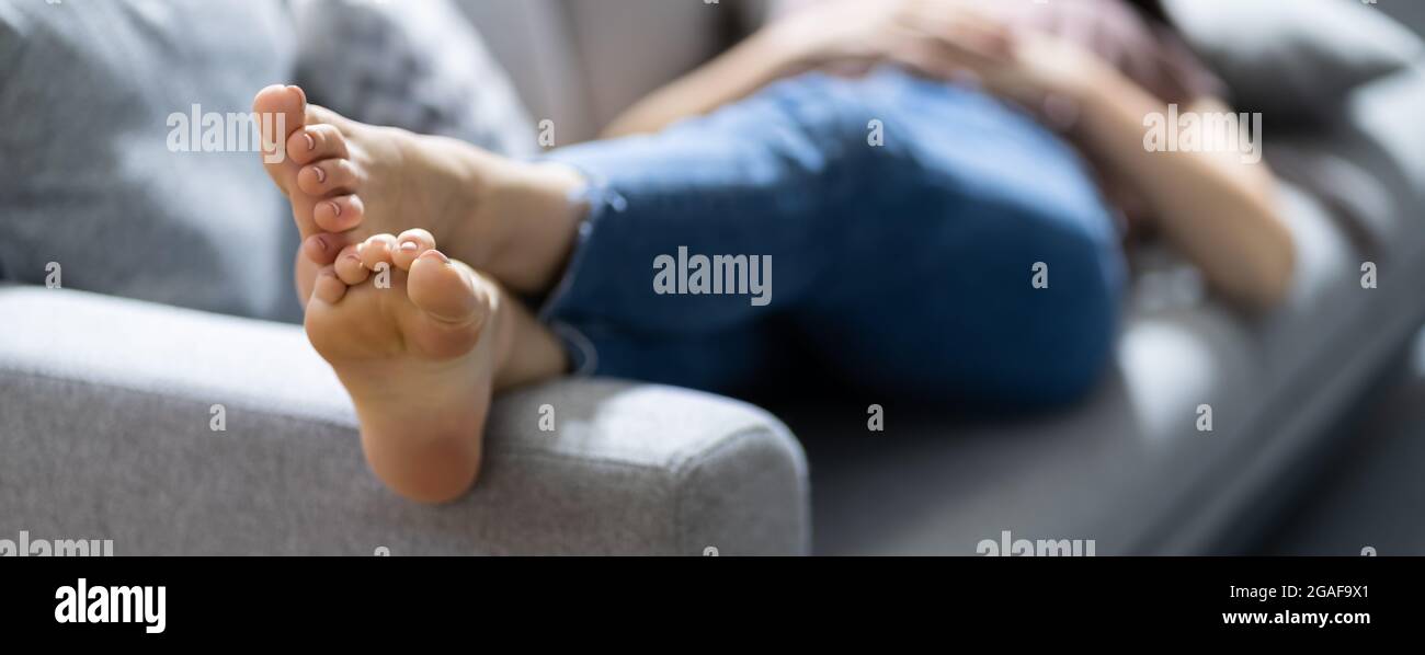 Barefoot girl lying on couch hires stock photography and images Alamy
