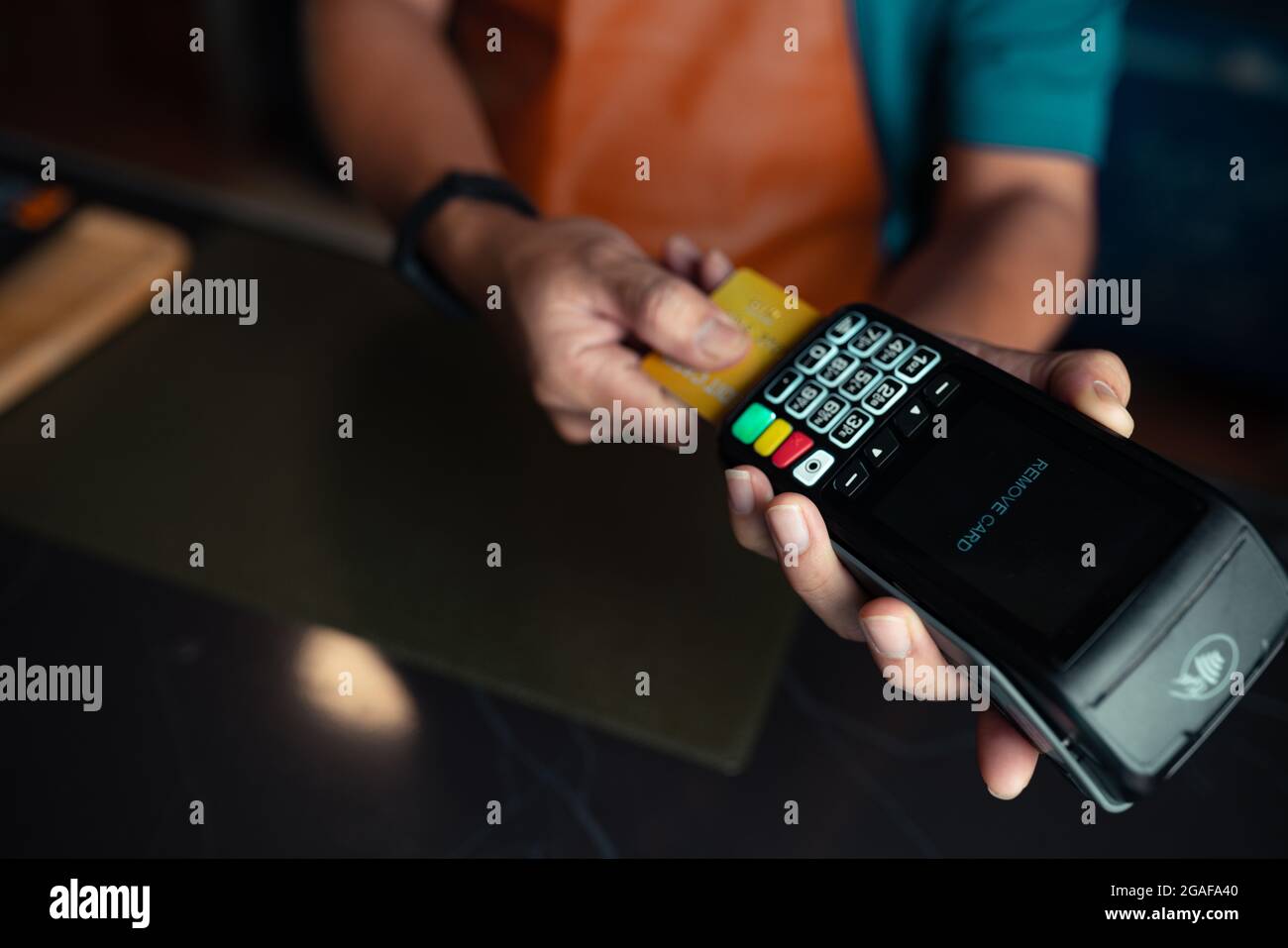 Payment by credit card via credit card swipe machine Stock Photo