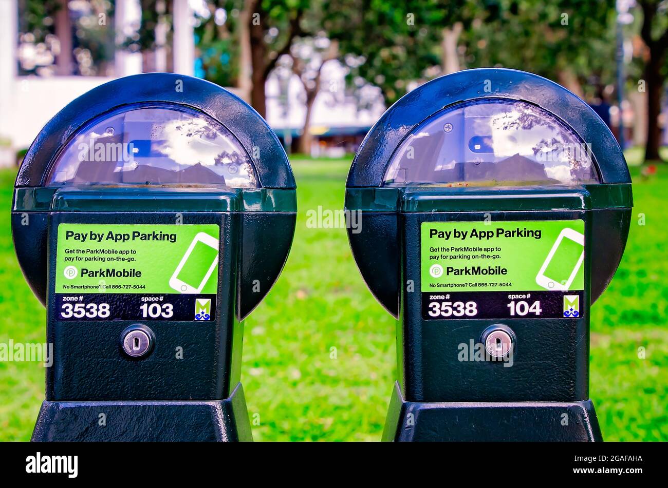 Pay by app parking meters stand on St. Francis Street at Bienville Square, July 28, 2021, in Mobile, Alabama. Stock Photo