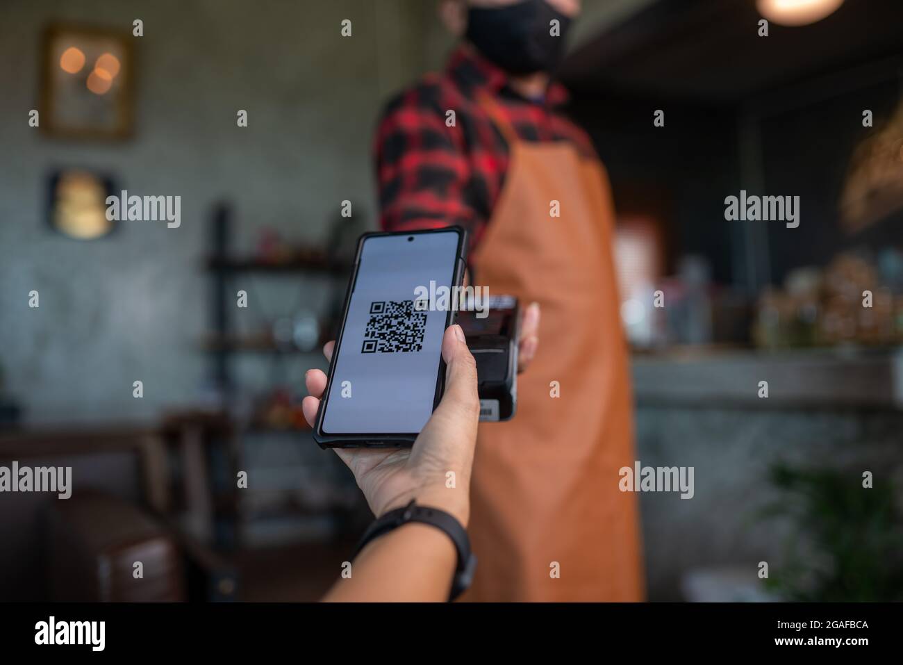 Payment by QR code via credit card swipe machine at the cafe Stock Photo