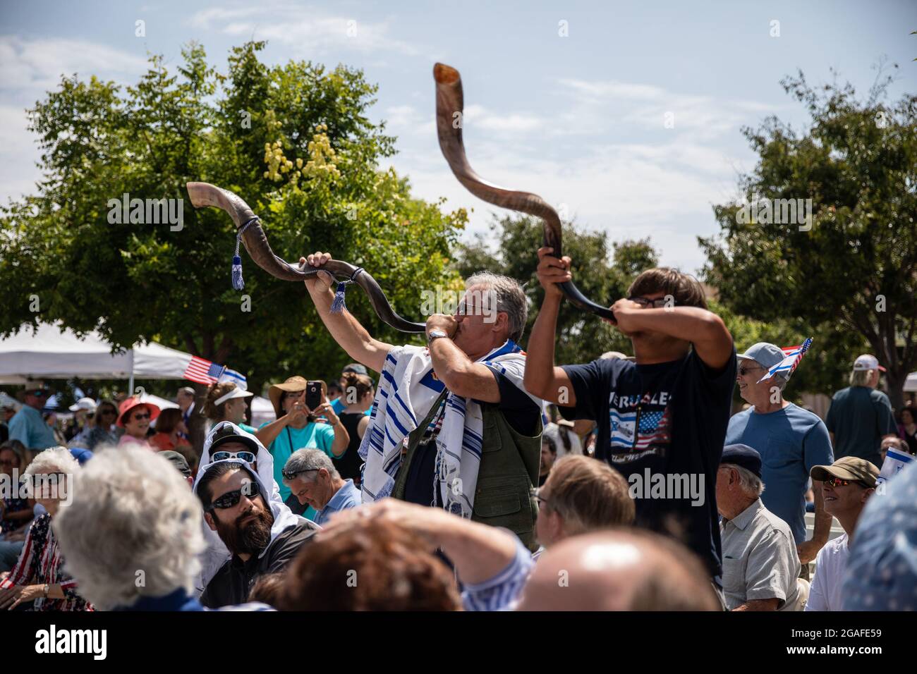 USA. 25th July, 2021. Attendees blow through horns during the “We Are Israel” rally in El Cajon, CA on Sunday, July 25, 2021. The rally, according to non-profit Shield of David, was created to “rally with Jews and Christians who boldly reject anti-Semitism and support Judeo-Christian values.” (Photo by Kristian Carreon/Sipa USA) Credit: Sipa USA/Alamy Live News Stock Photo