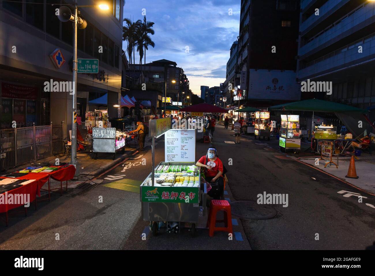 A vendor seen waiting for customers in Wanhua night market amid covid-19 pandemic. As the number of confirmed coronavirus cases has continued to dip lately, Central Epidemic Command Center (CECC) said that the CECC is planning to draw up epidemic management guidance for restaurants and night markets that would allow them to reopen. Stock Photo