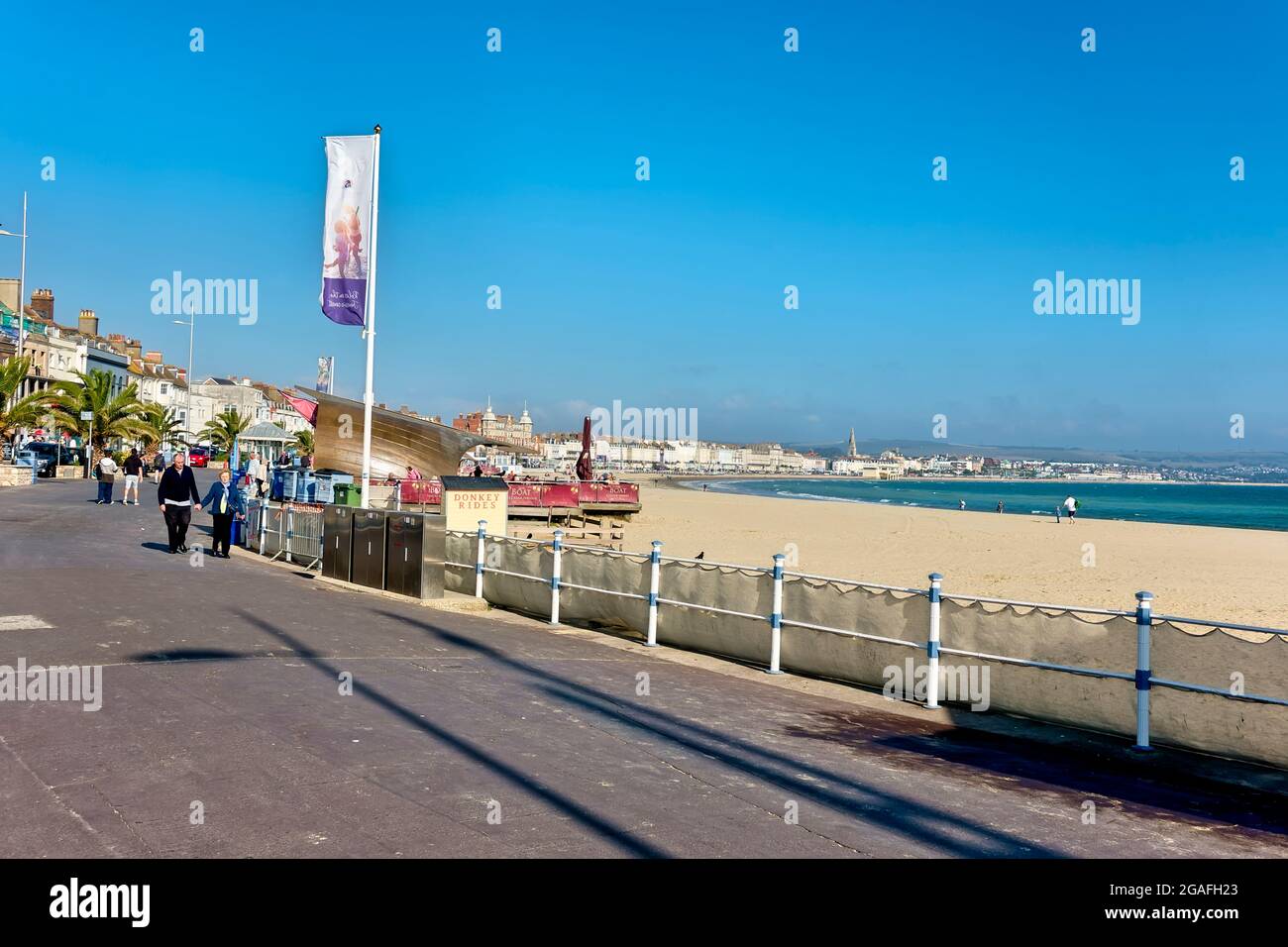 Weymouth, Dorset, UK - October 10 2018: People walking on an almost deserted Weymouth Promenade and beach in Dorset, England, UK Stock Photo