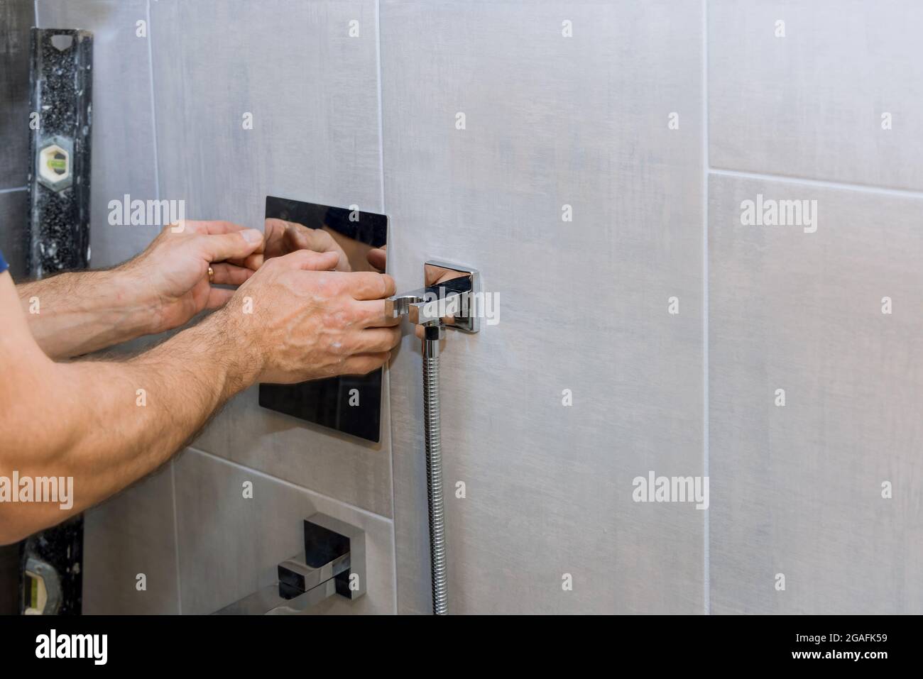 Plumber hands fixing shower mixer on modern water tap Stock Photo Alamy