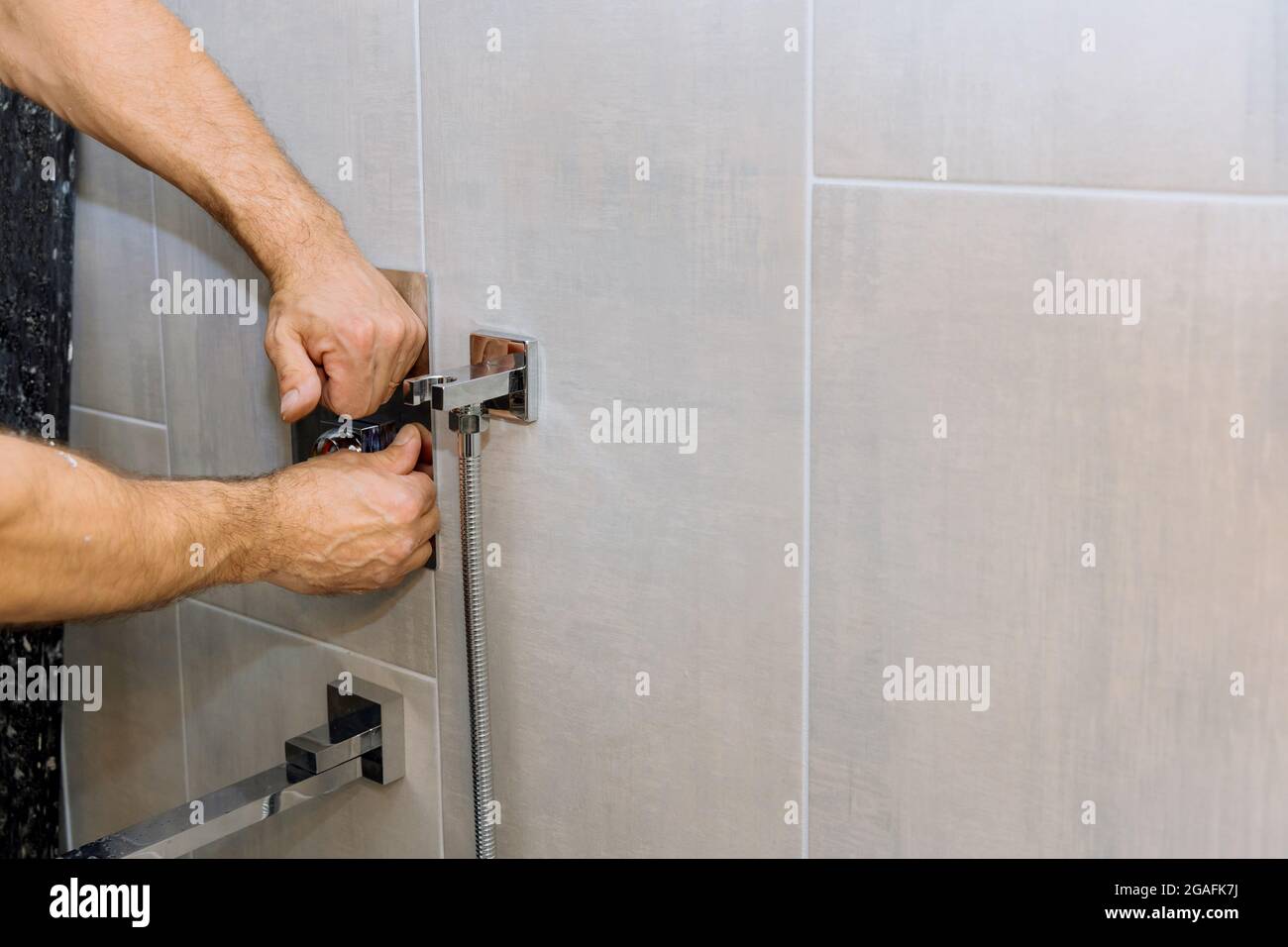 Installing a new on shower mixer tap in a bathroom Stock Photo Alamy