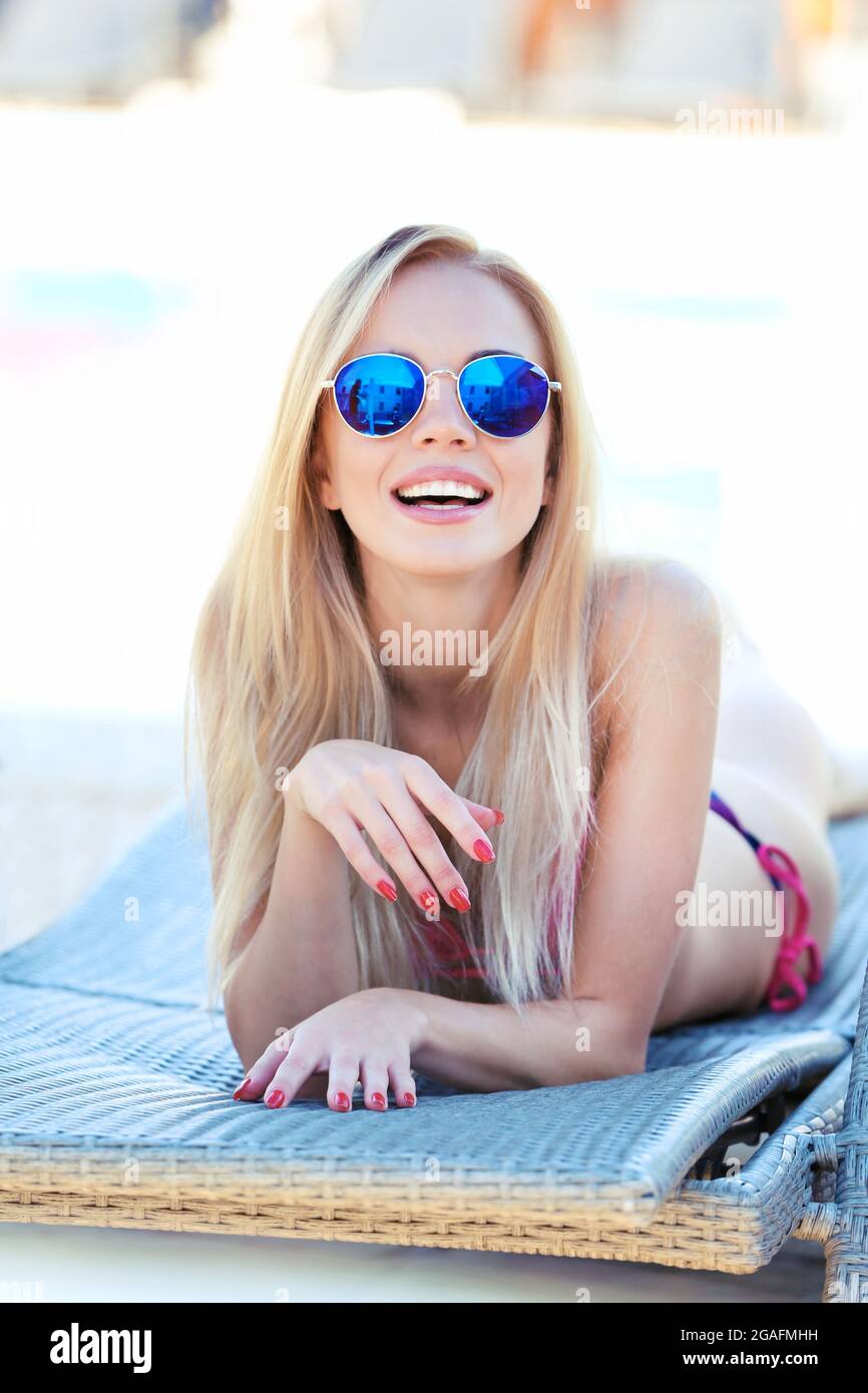 Young girl relaxing on chaiselounge Stock Photo Alamy