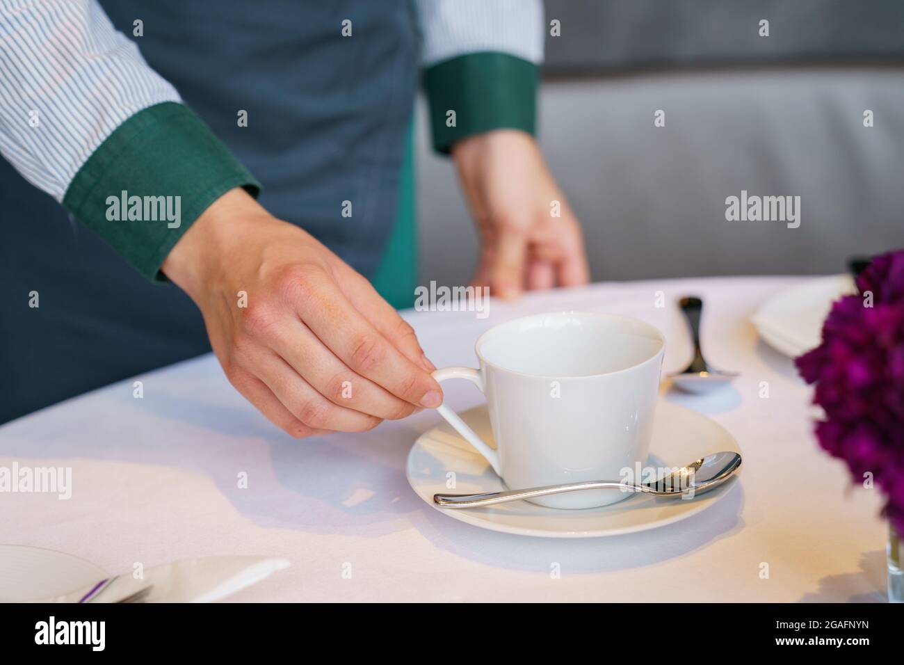 Waiting staff prepare a table in a restaurant Stock Photo Alamy