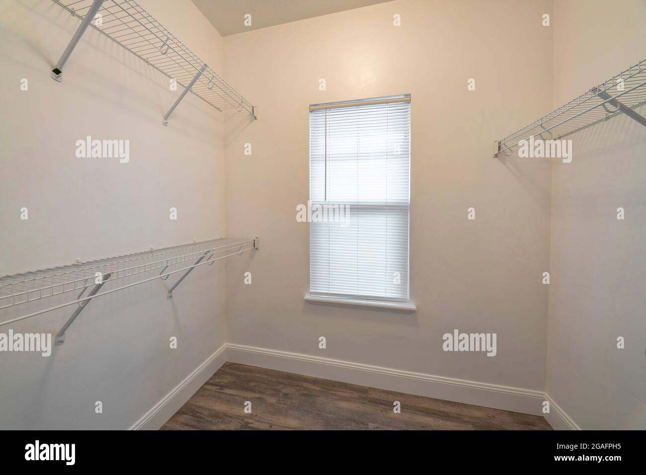 Small Empty Walk In Closet With Wall Mounted Steel Wire Shelves Stock 