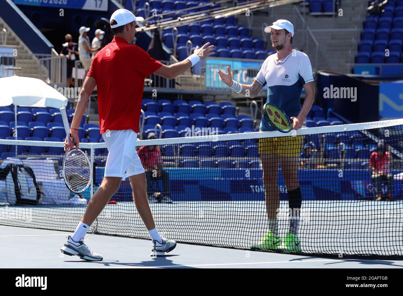 Tokyo, Japan, 24 July, 2021. Daniil Medvedev of Russian Olympic Committee congratulates Alexander Bublik of Kazakhstan at the net during the Men's Tennis Round 1 match. Credit: Pete Dovgan/Speed Media/Alamy Live News Stock Photo