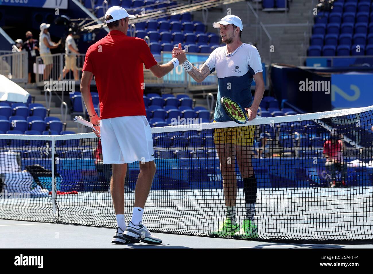 Tokyo, Japan, 24 July, 2021. Daniil Medvedev of Russian Olympic Committee congratulates Alexander Bublik of Kazakhstan at the net during the Men's Tennis Round 1 match. Credit: Pete Dovgan/Speed Media/Alamy Live News Stock Photo