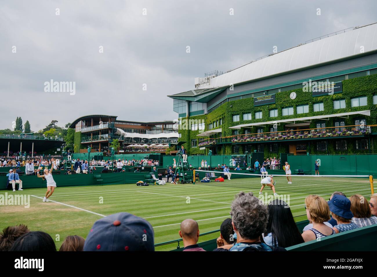 General views of A. Krunic and N. Stojanovic of Serbia takes on H. Carter of the USA and L. Stefani of Brazil at Wimbledon with Centre Court behind Stock Photo