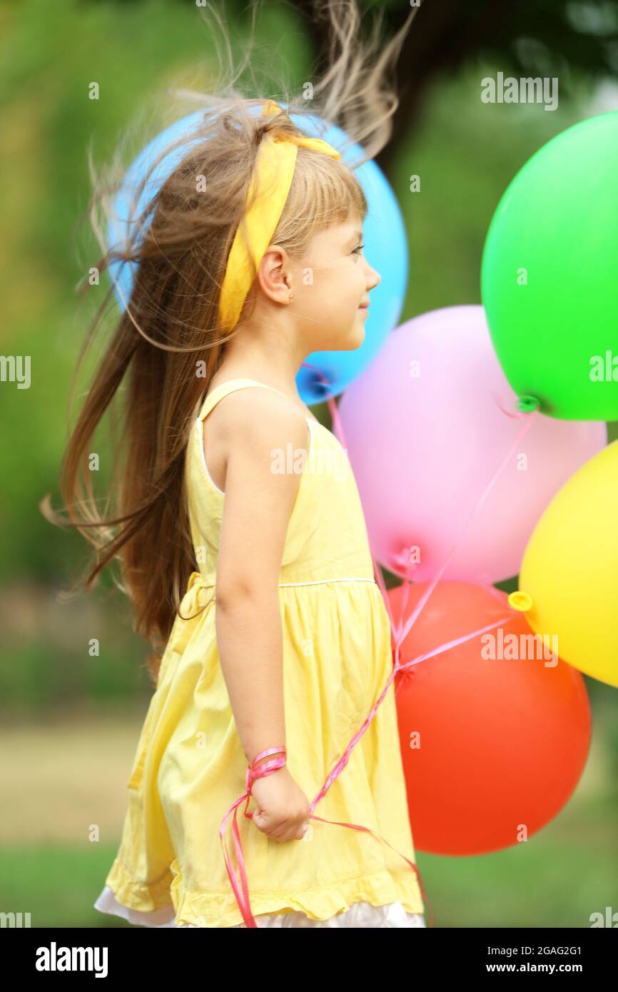 Little girl with balloons outside Stock Photo Alamy