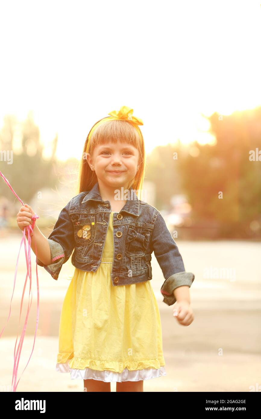 Little girl with balloons outside Stock Photo - Alamy