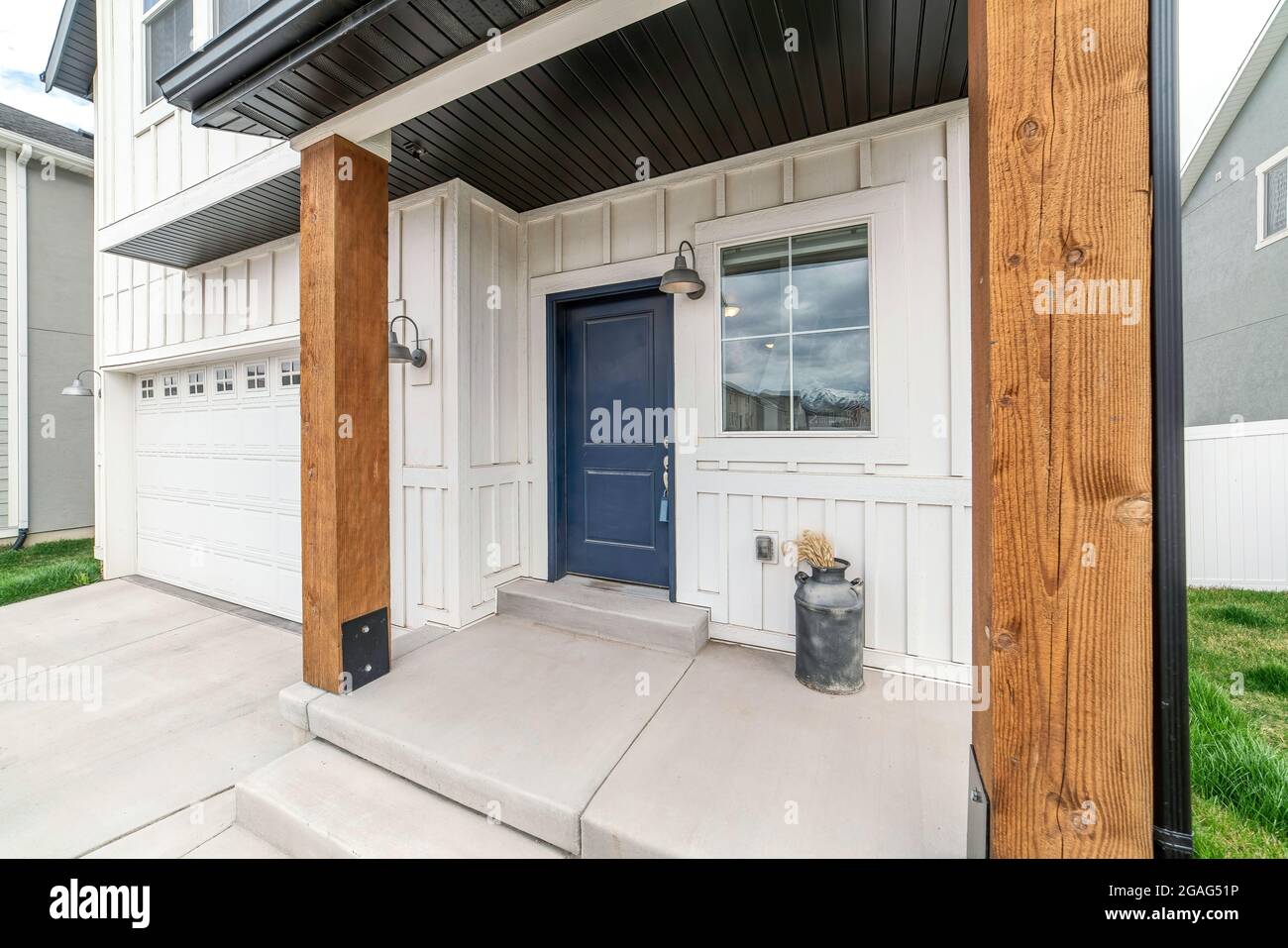 Twostorey house exterior with garage and board and batten siding Stock