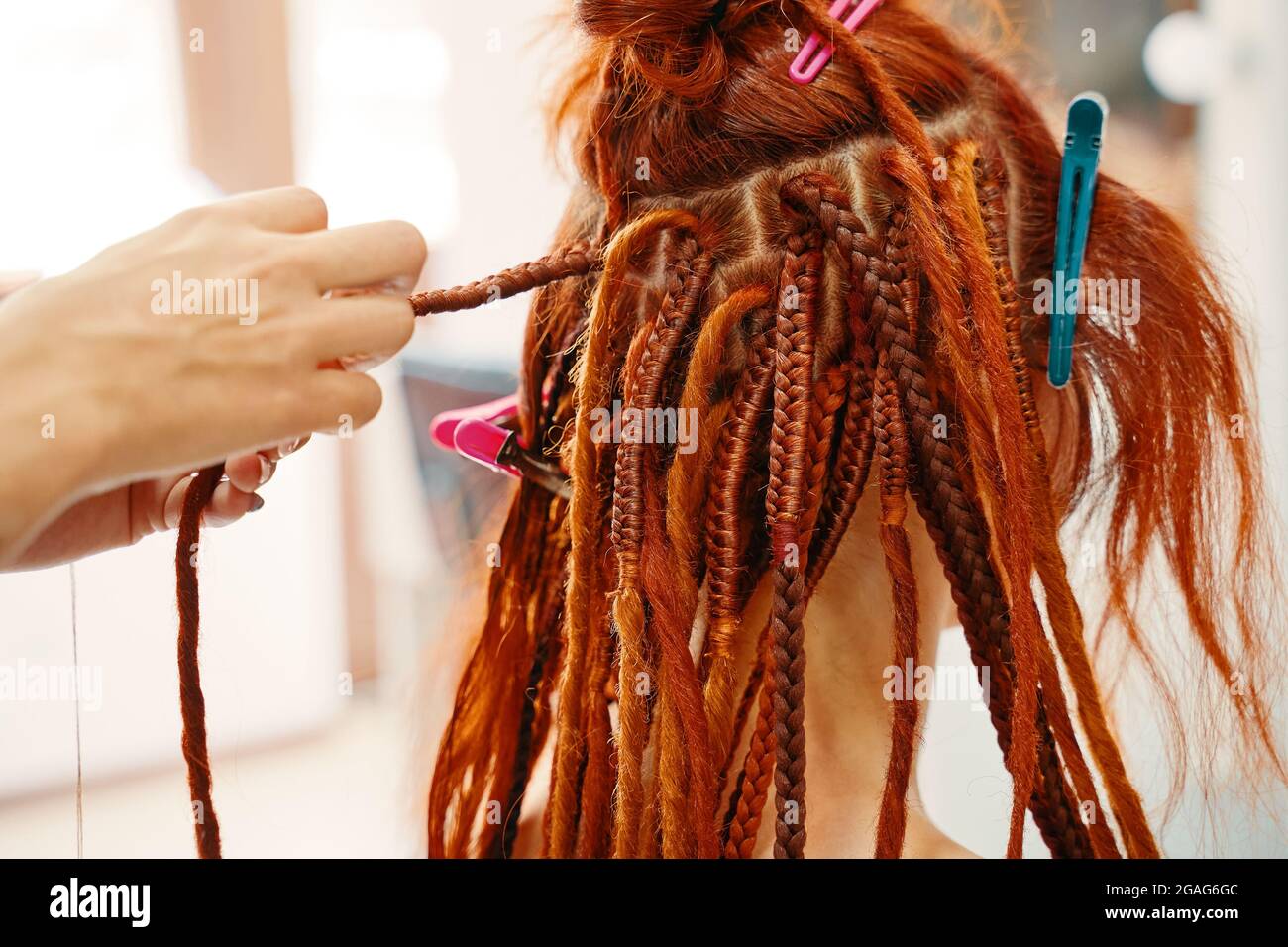 Braiding process african plaits with colored kanekalon. Hairdresser weaves woman ginger dreadlocks. Bright pigtails on head. Hippie style hairstyle. Beauty salon services Stock Photo - Alamy Braiding process african plaits with colored kanekalon. Hairdresser weaves woman ginger dreadlocks. Bright pigtails on head. Hippie style hairstyle. Beauty salon services Stock Photo - Alamy