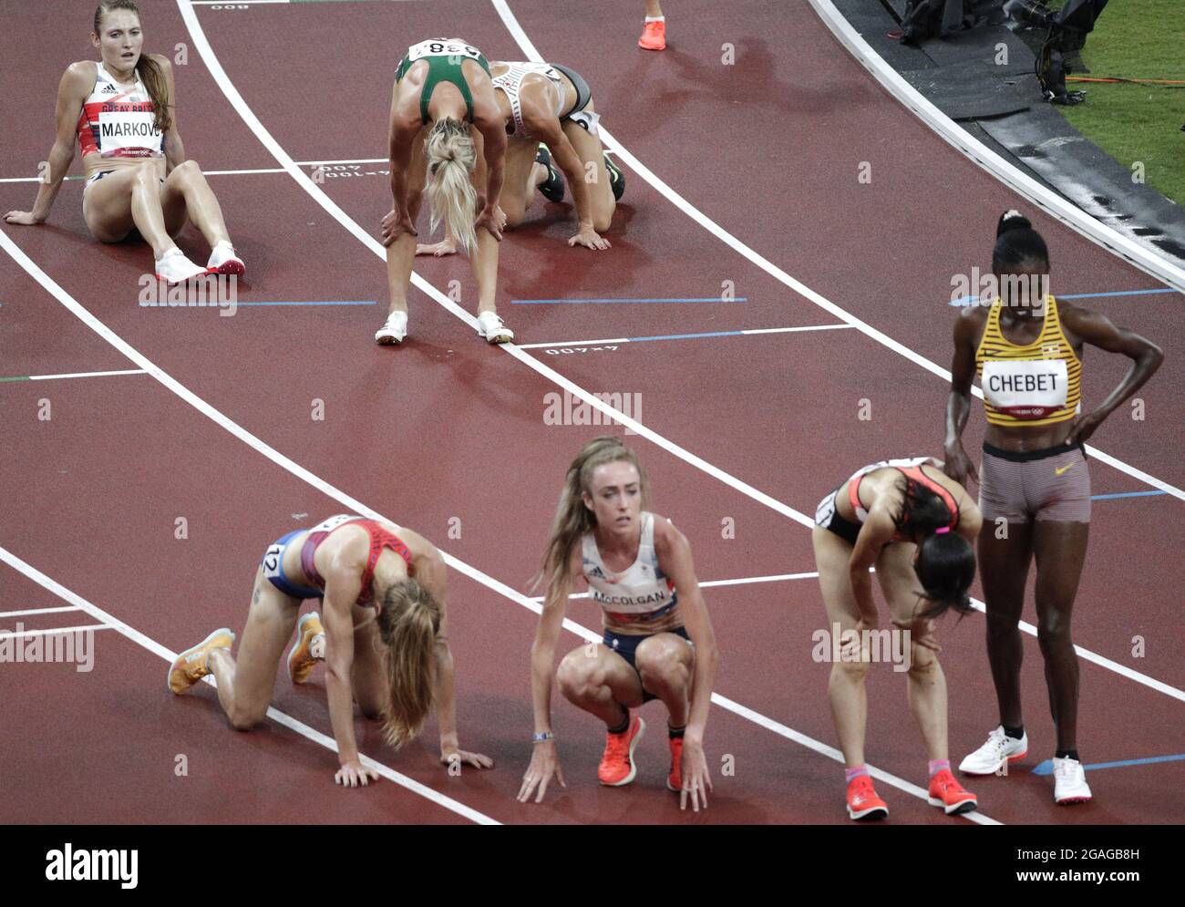 Tokyo, Japan. 30th July, 2021. Athletes recover on the track after
